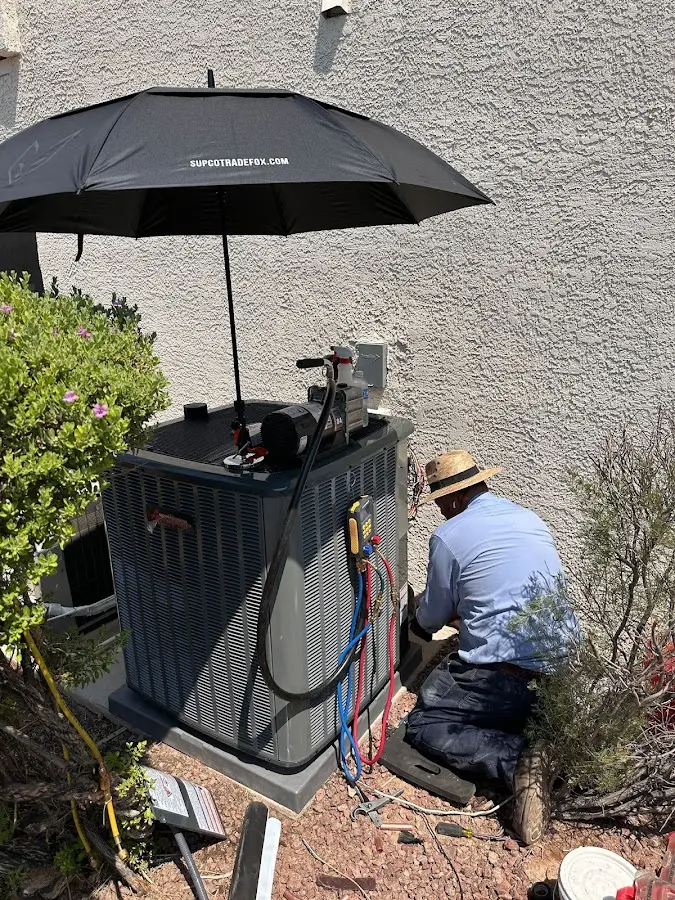 HVAC technician performing outdoor AC maintenance in Lake Barcroft